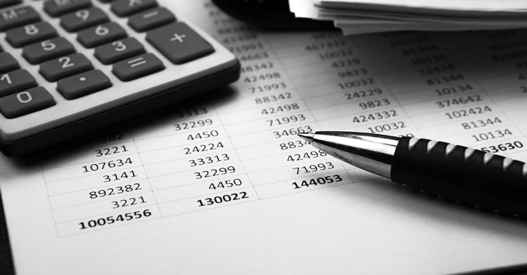 Accounting paperwork with pen and calculator | Numerico Livonia, MI | CPA In Livonia, MI