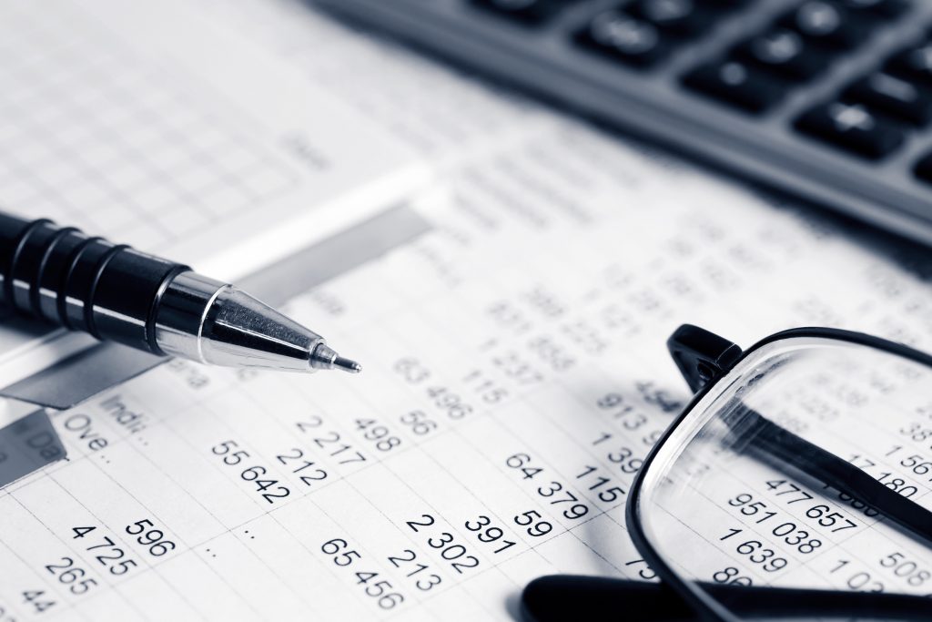 Nonprofit Budgeting With Pen, Glasses and Balance Sheet
